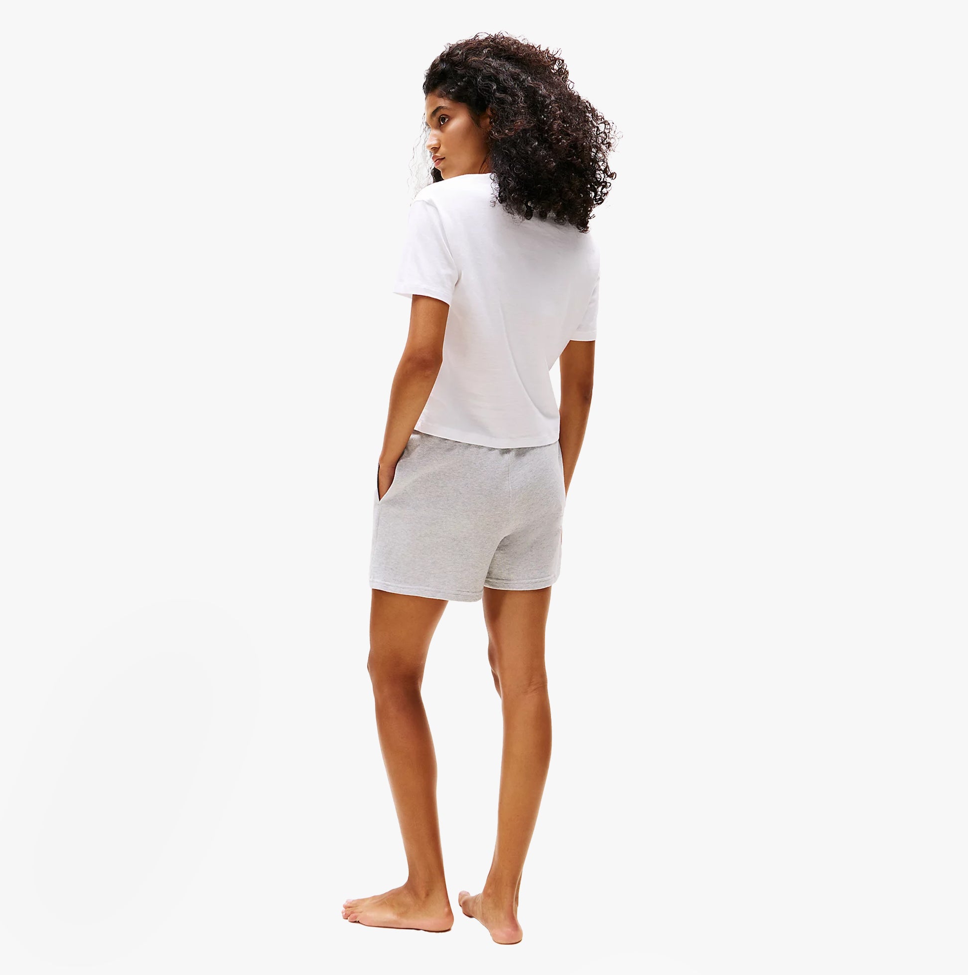 Tommy Hilfiger PURE COTTON Relaxed T-Shirt Womens White back view with casual shorts and curly hair model.