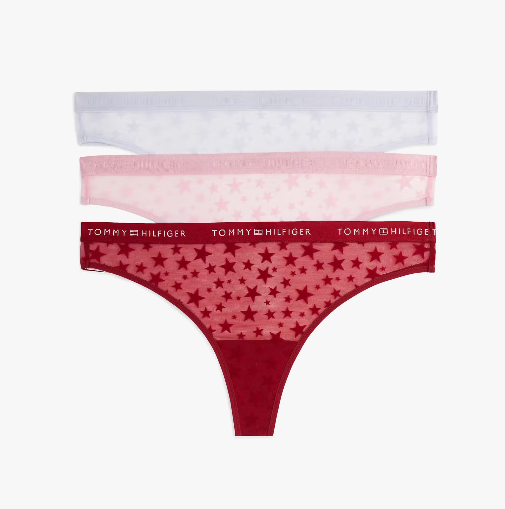 Tommy Hilfiger GIFT 3 PACK THONG Womens Thong Multicoloured, featuring a front view of red, pink, and purple thongs with star patterns.