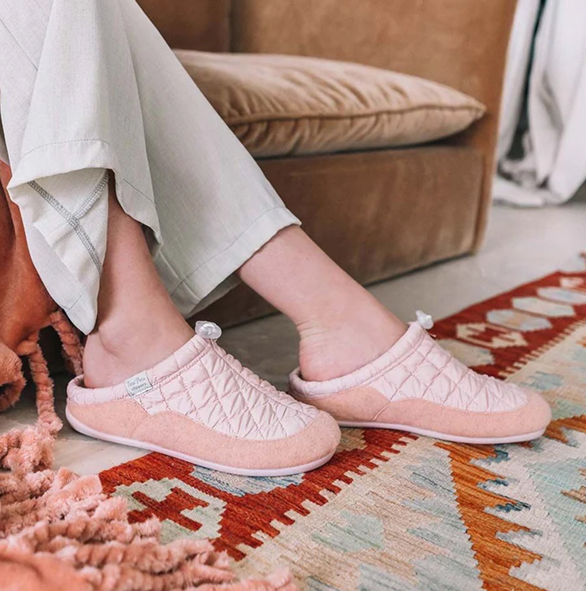 Toni Pons MEL-UM Womens Slippers Nude side view worn on feet with cozy home background and patterned rug.