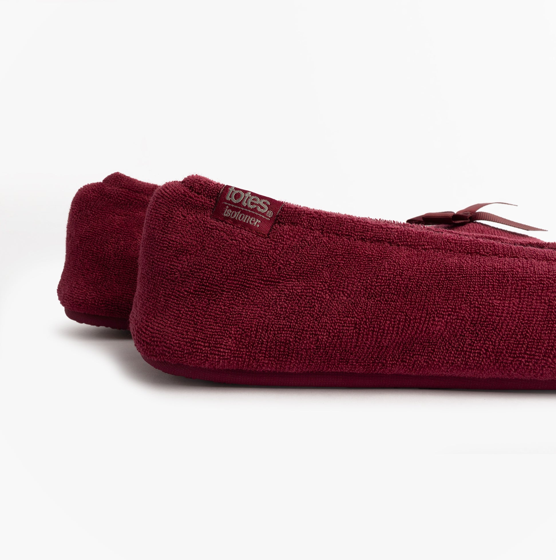 Totes Isotoner STRETCH TERRY BOW Womens Ballerina Slippers Burgundy side view showcasing soft terry cloth material and bow detail.