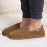 Totes Isotoner REAL SUEDE FULL BACK Mens Full Back Slippers Tan side view worn by a person in casual attire.