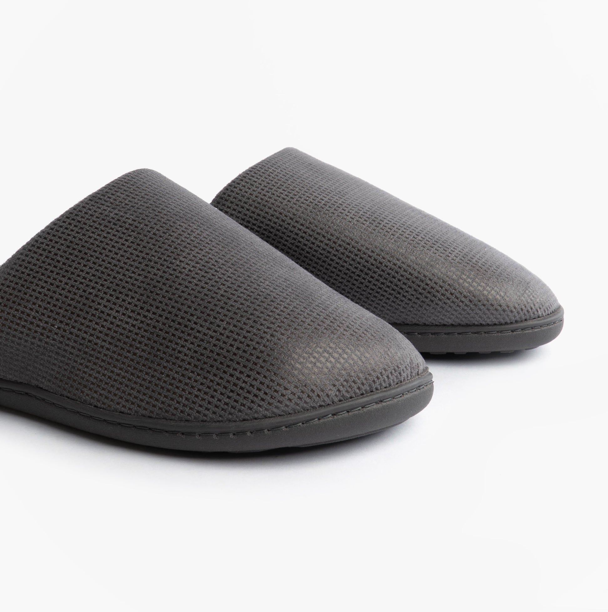 Totes Isotoner SQUARE PATTERNED SMART MULE Mens Mule Slippers Grey side view showing textured upper and rounded toe shape.