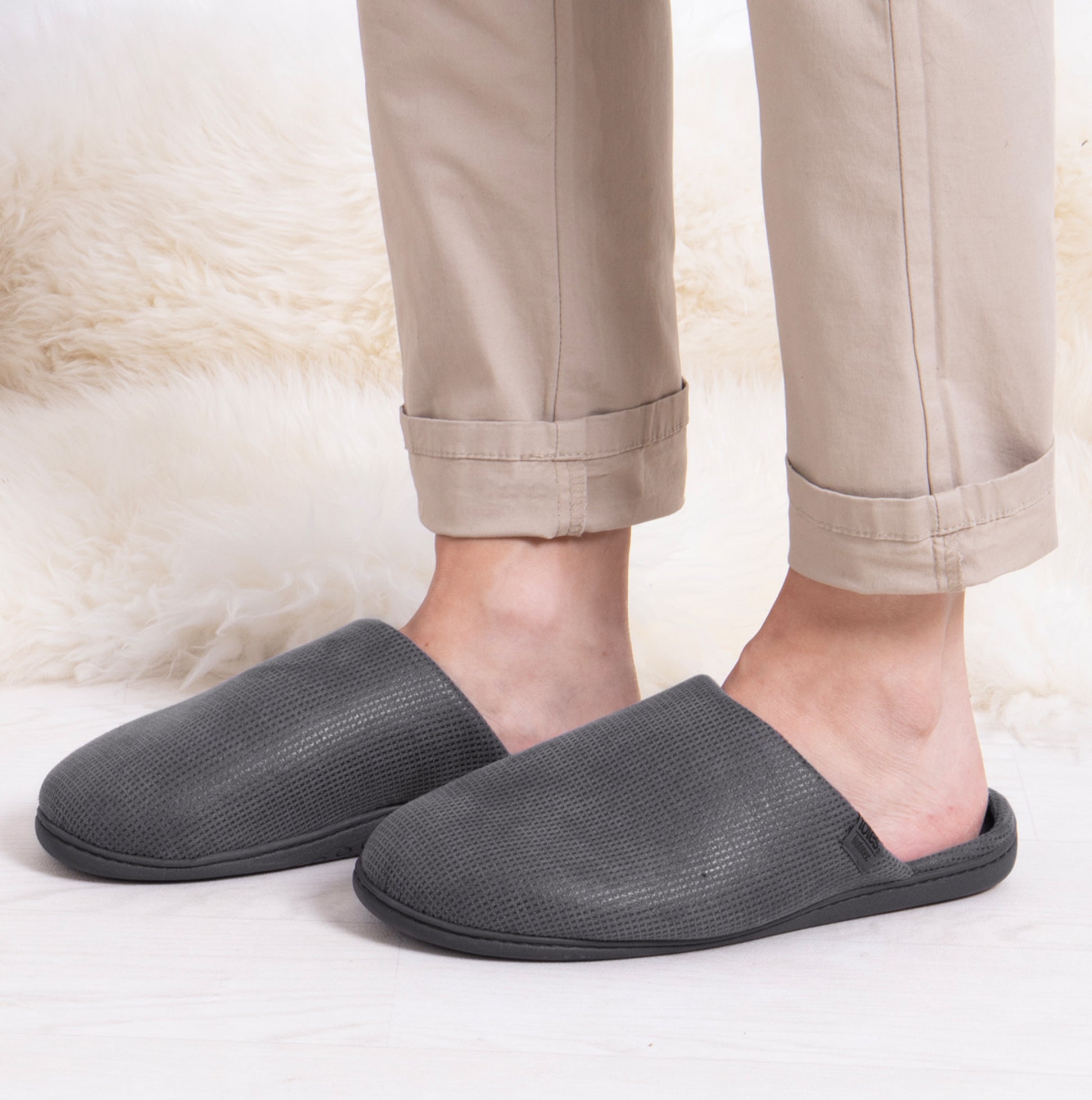 Totes Isotoner SQUARE PATTERNED SMART MULE Mens Mule Slippers Grey side view on feet with beige pants
