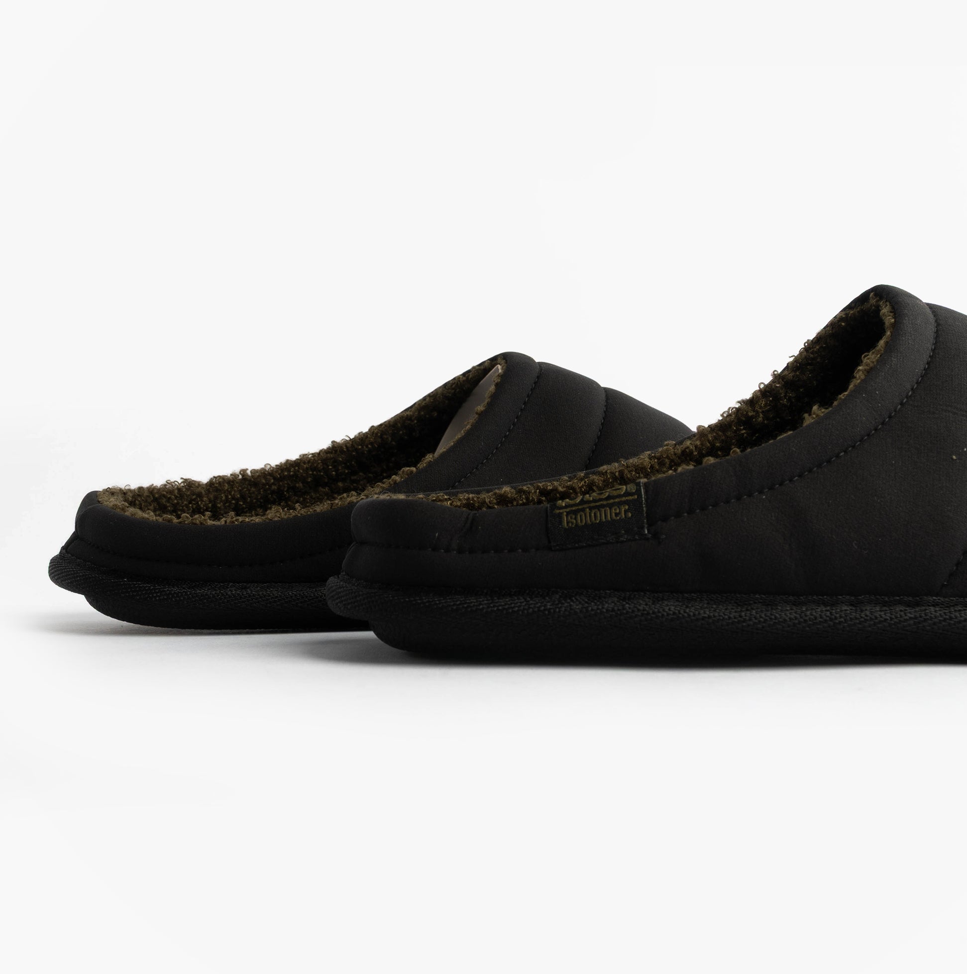 Totes Isotoner SPORT QUILTED MULE WITH COSY LINING Mens Mule Slippers Black side view showing soft lining and textured sole.