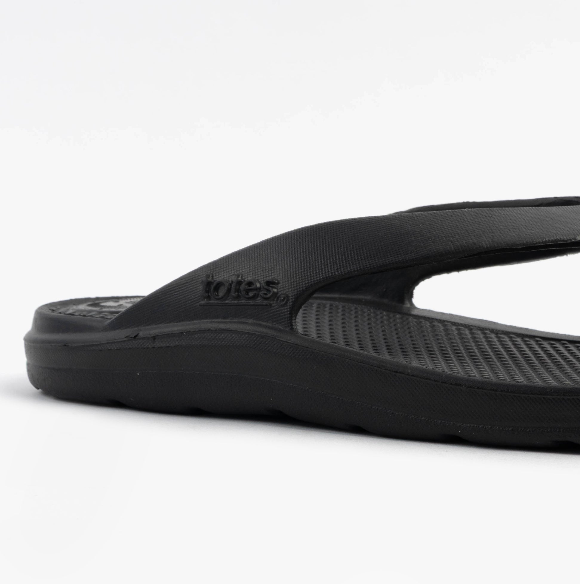 Totes Sol Bounce 0350FBLK Womens Toe Post Sandals Black side view showing lightweight synthetic upper and flat sole.