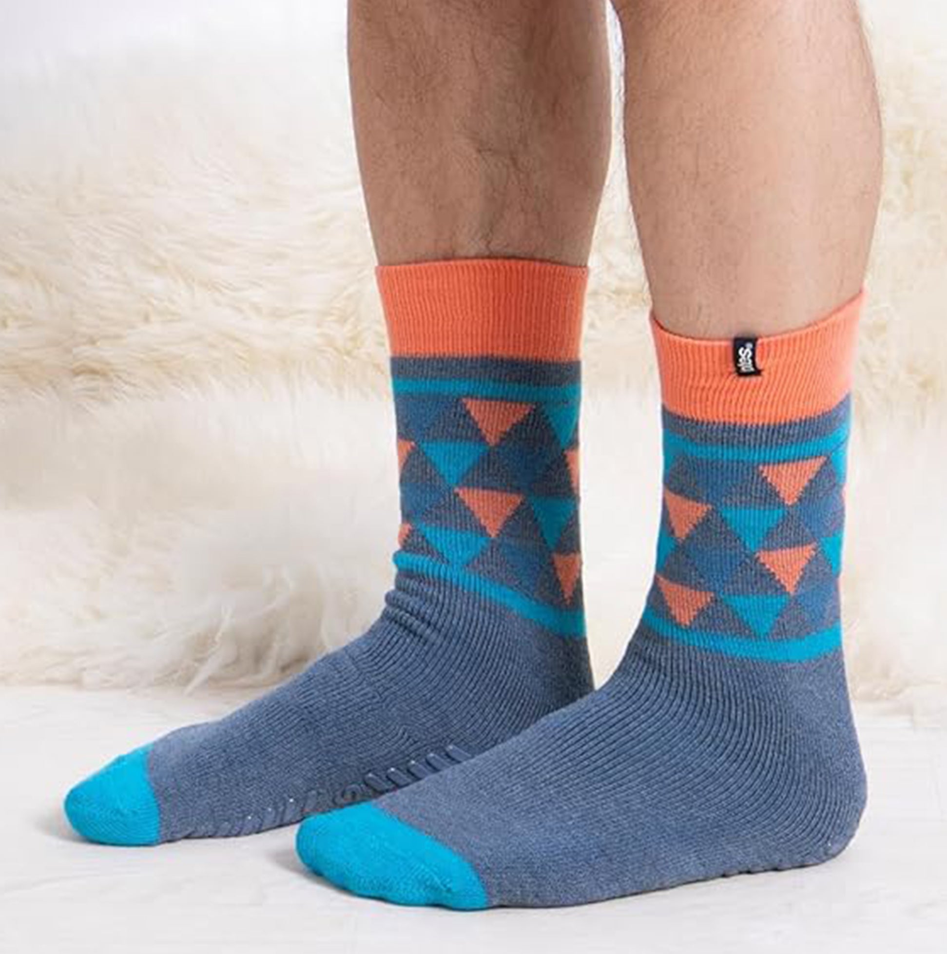 Totes Toasties ORIGINAL SLIPPER SOCKS (TWIN PACK) Mens Socks Yeti side view showing colorful patterns and slip-resistant tread.