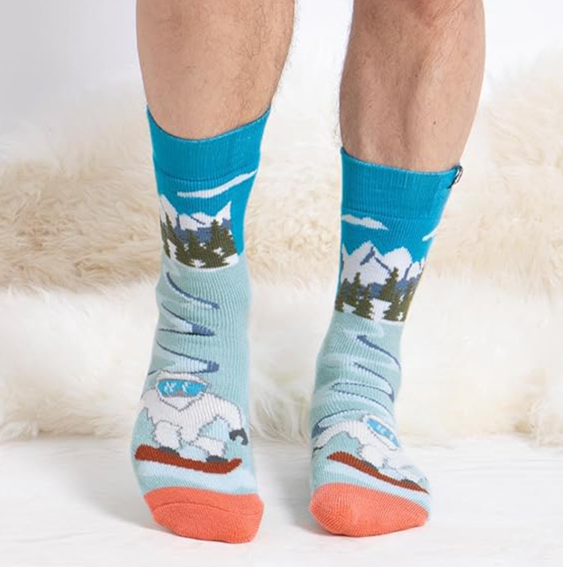 Totes Toasties ORIGINAL SLIPPER SOCKS (TWIN PACK) Mens Socks Yeti front view showing colorful Yeti design and mountain scenery.