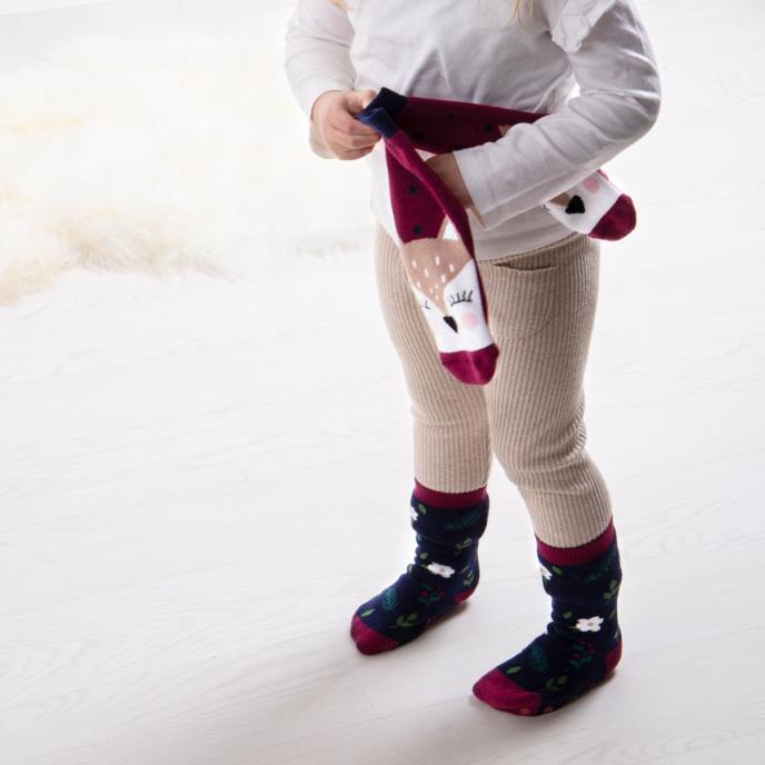Totes Toasties ORIGINAL Slipper Socks (Twin Pack) Unisex Kids Socks Deer, front view of child wearing socks.