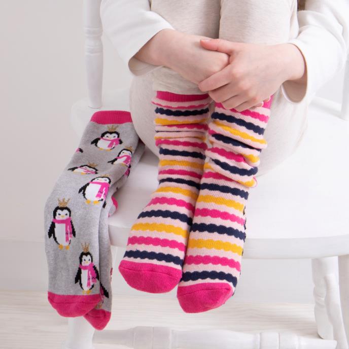 Totes Toasties ORIGINAL Slipper Socks (Twin Pack) Unisex Kids Socks Penguin / Stripe, front view of socks on child's feet.