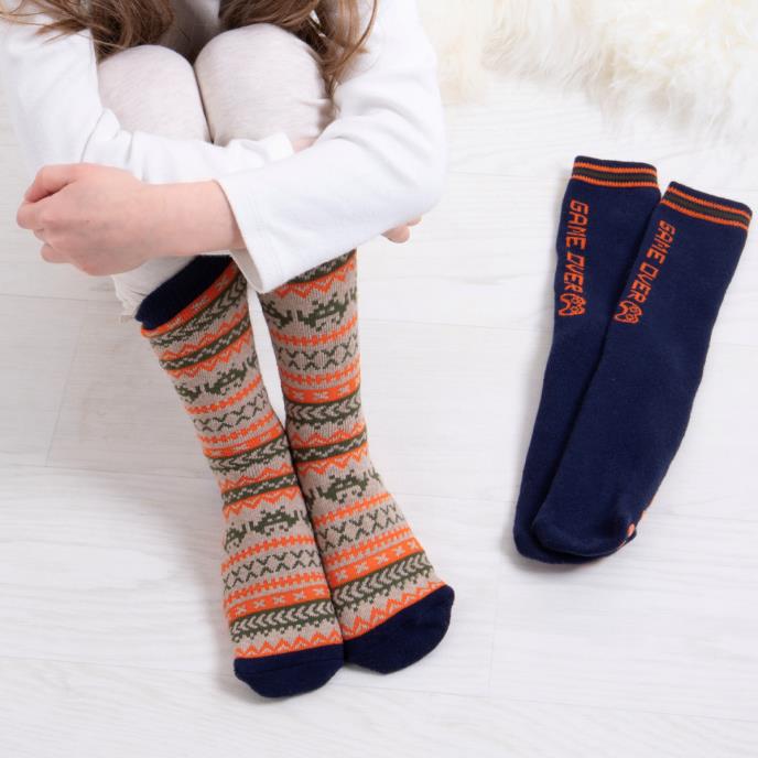 Totes Toasties ORIGINAL Slipper Socks (Twin Pack) Unisex Kids Socks Game, side view of colorful patterned socks and navy blue socks.