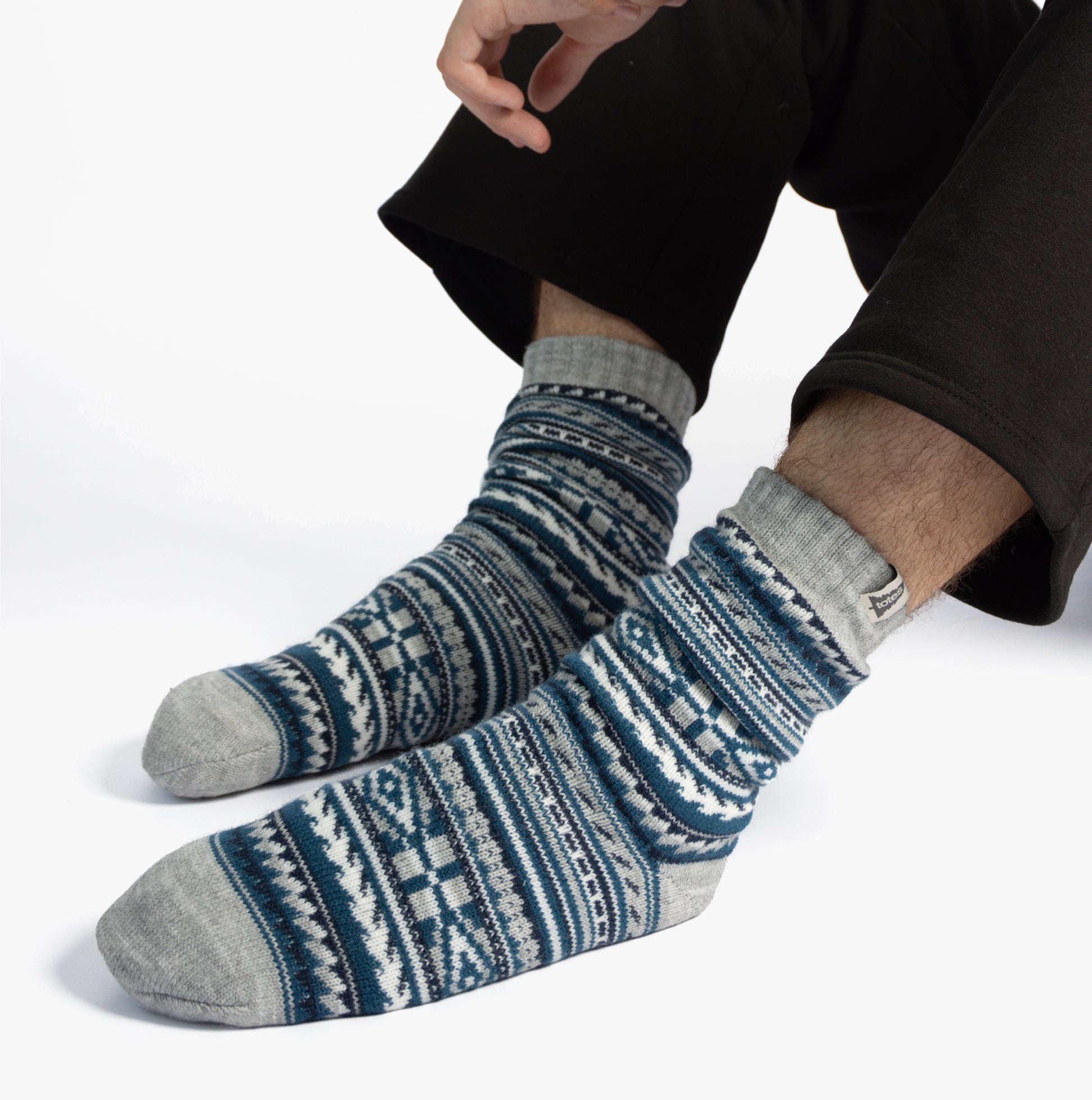 Totes Toasties SHERPA LINED FAIR ISLE Mens Slippers Socks Blue Fair isle showing feet from front view, highlighting Fair Isle design and soft texture.
